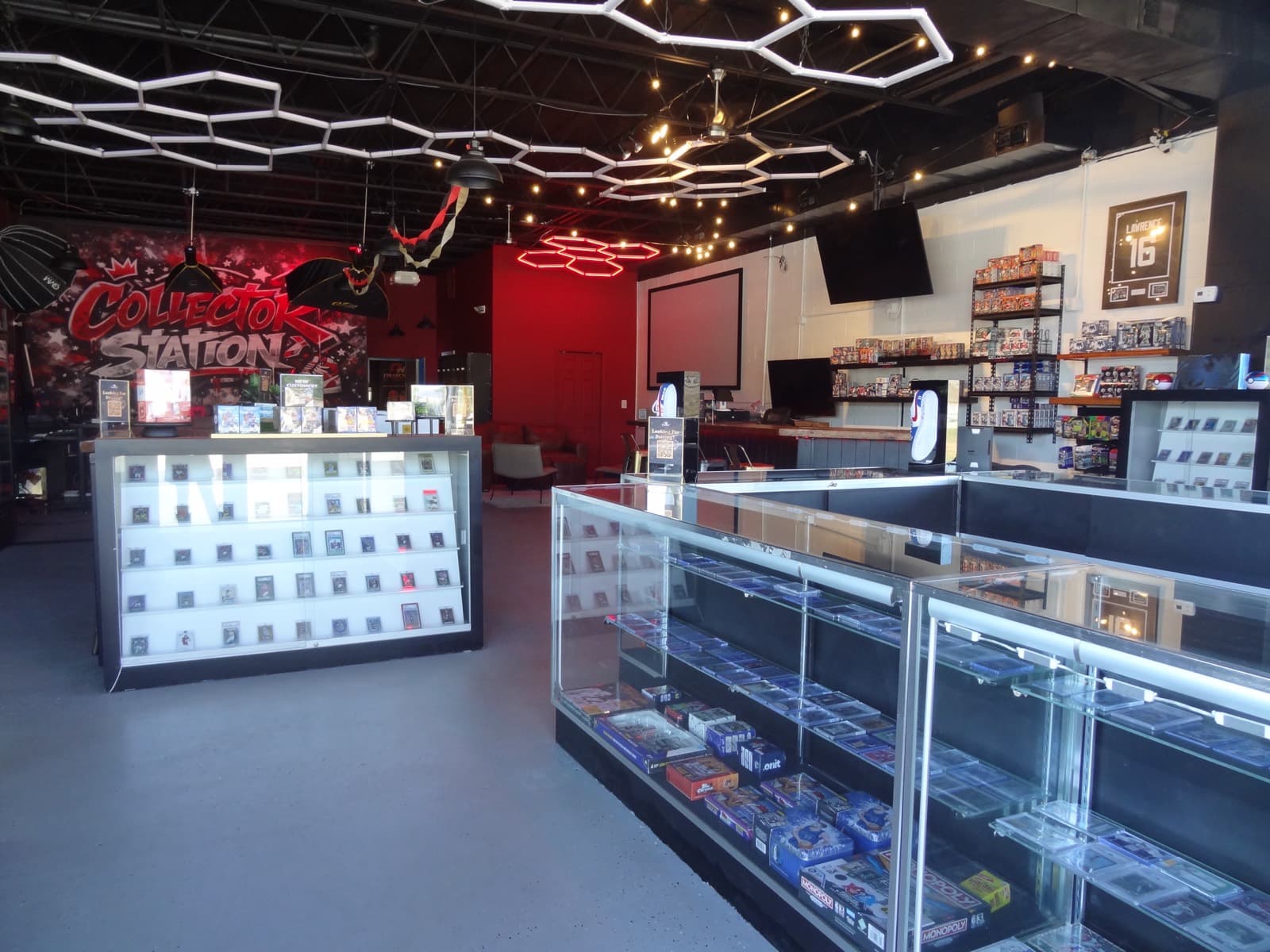 Collector Station shop floor — showcases under hex lighting